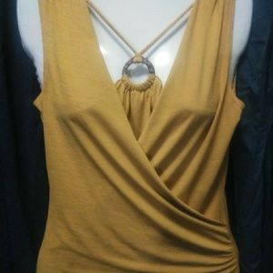 Mustard shirt with really cute wood circle in fron